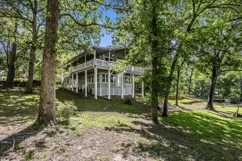 a view of a house with garden and trees