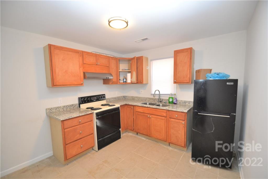 1701 Springdale Road Lancaster, SC 29720 - Photo 3 of 8 a kitchen with a refrigerator and a stove top oven