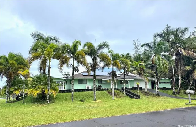 a view of a swimming pool with a garden and trees