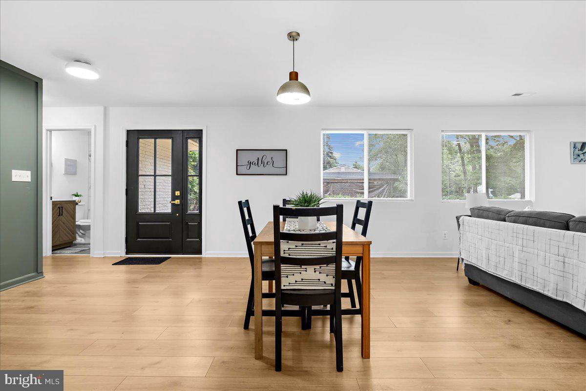 624 Sutton Drive Pasadena, MD 21122 - Photo 12 of 64 a view of a dining room with furniture and wooden floor