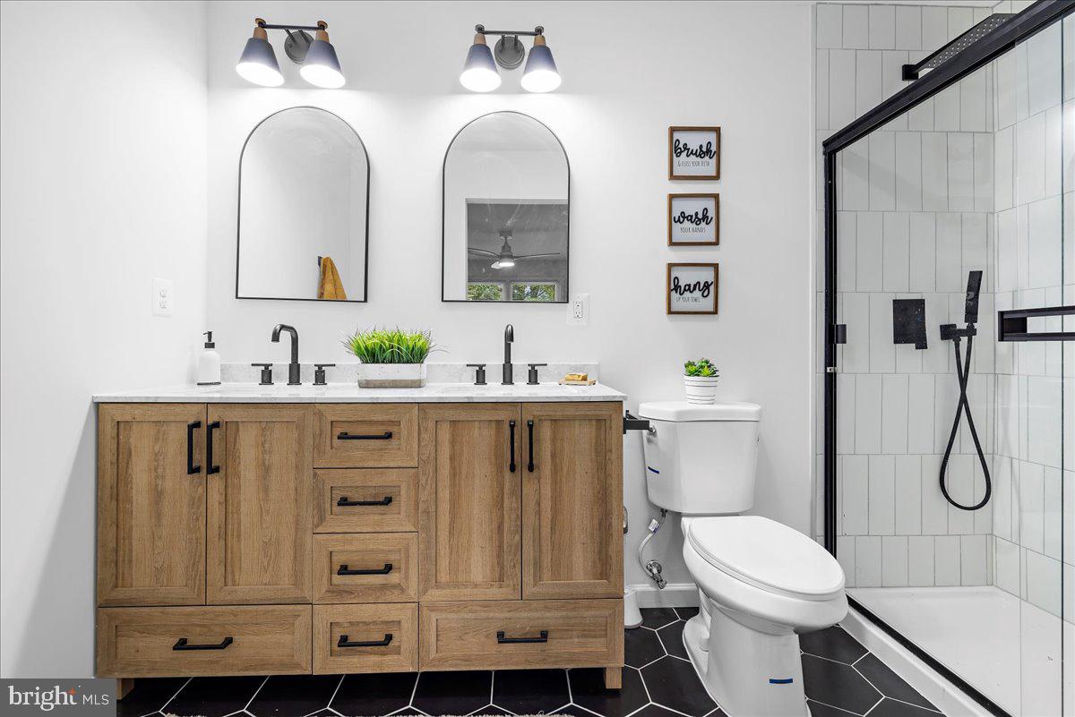 624 Sutton Drive Pasadena, MD 21122 - Photo 19 of 64 a bathroom with a toilet sink and mirror