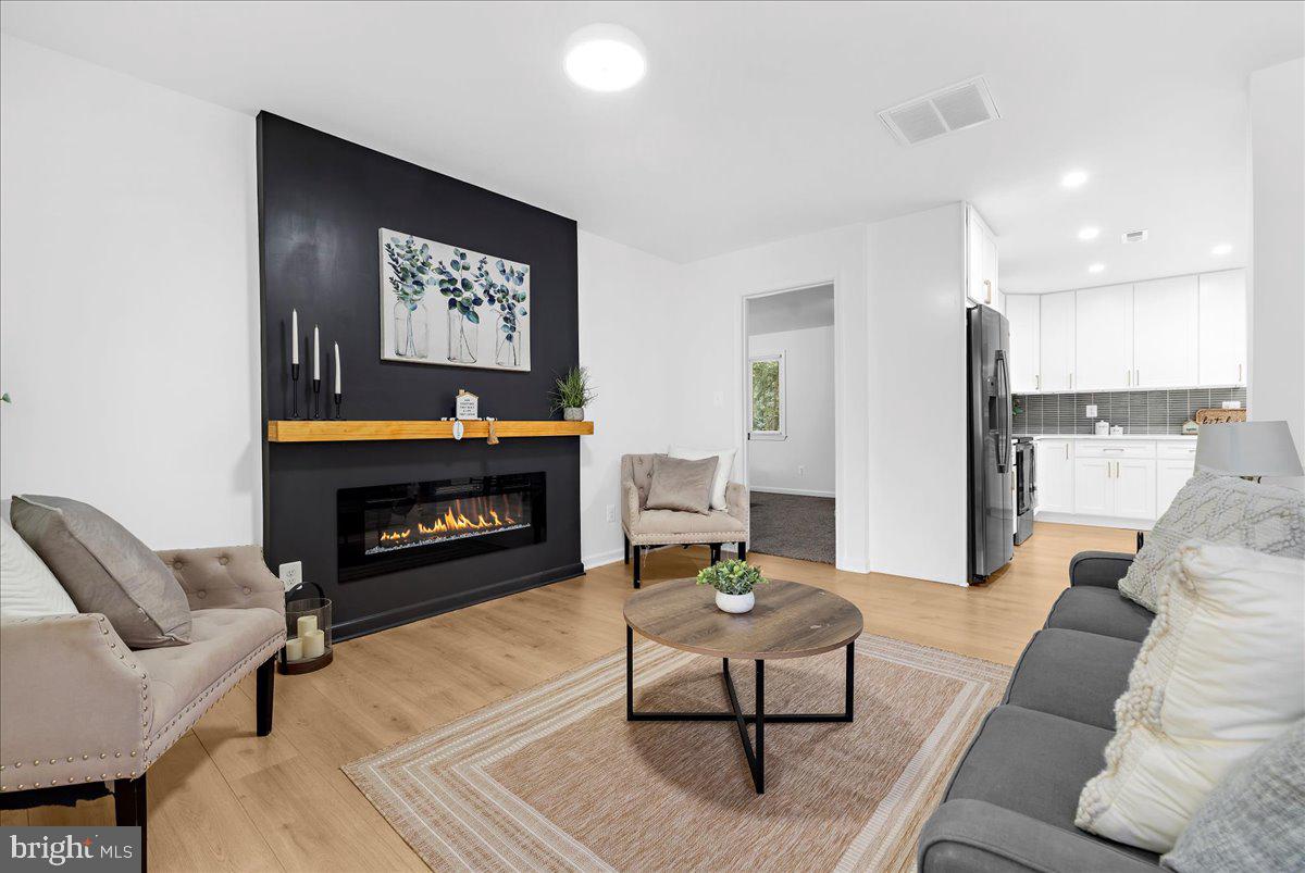 624 Sutton Drive Pasadena, MD 21122 - Photo 2 of 64 a living room with furniture and a fireplace