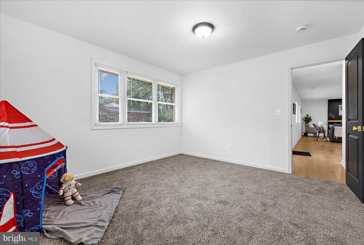 624 Sutton Drive Pasadena, MD 21122 - Photo 26 of 64 an empty room with a fireplace and painted walls