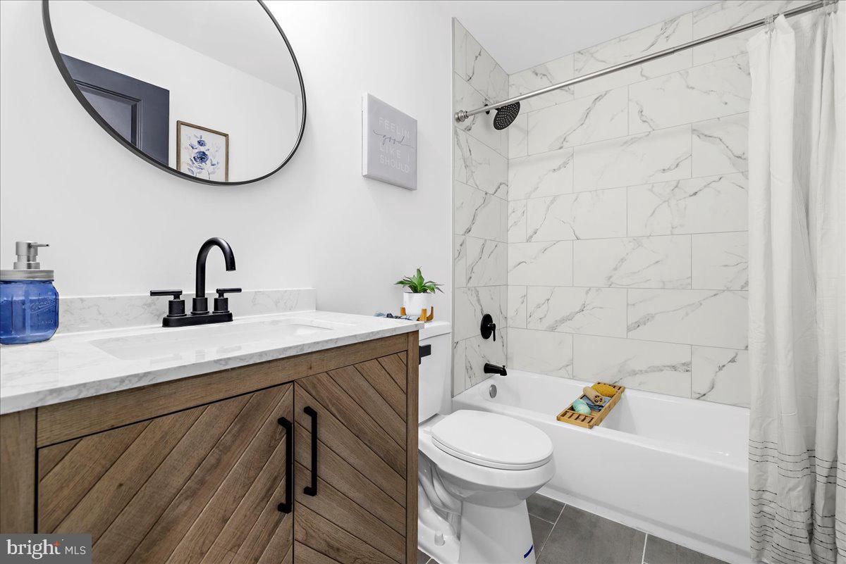 624 Sutton Drive Pasadena, MD 21122 - Photo 29 of 64 a bathroom with a sink a toilet and a mirror