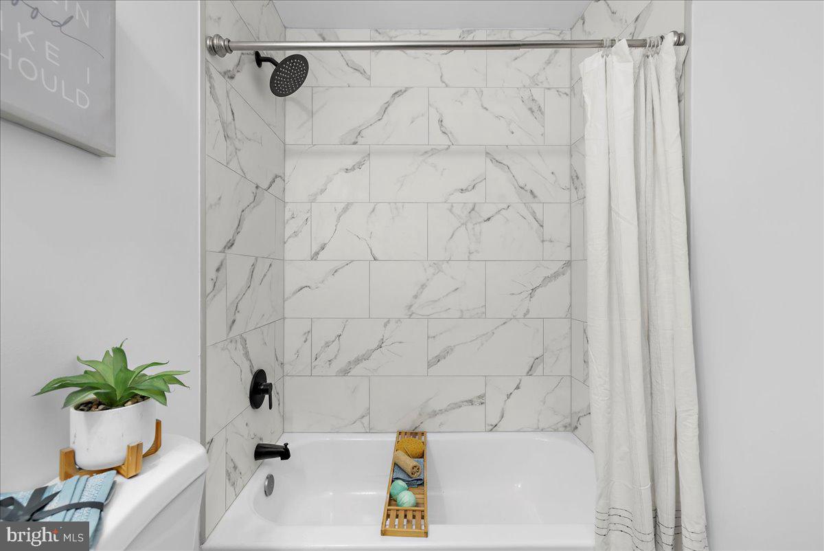 624 Sutton Drive Pasadena, MD 21122 - Photo 30 of 64 a bathroom with a bathtub and a shower