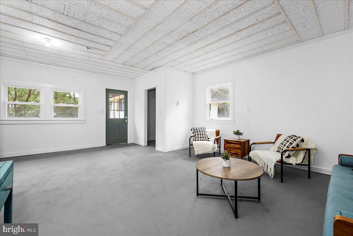 624 Sutton Drive Pasadena, MD 21122 - Photo 34 of 64 a living room with furniture a table and a window