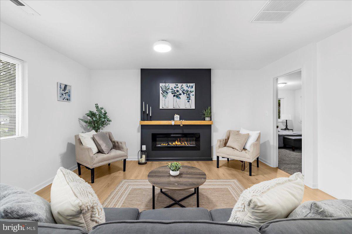 624 Sutton Drive Pasadena, MD 21122 - Photo 4 of 64 a living room with furniture and a fireplace