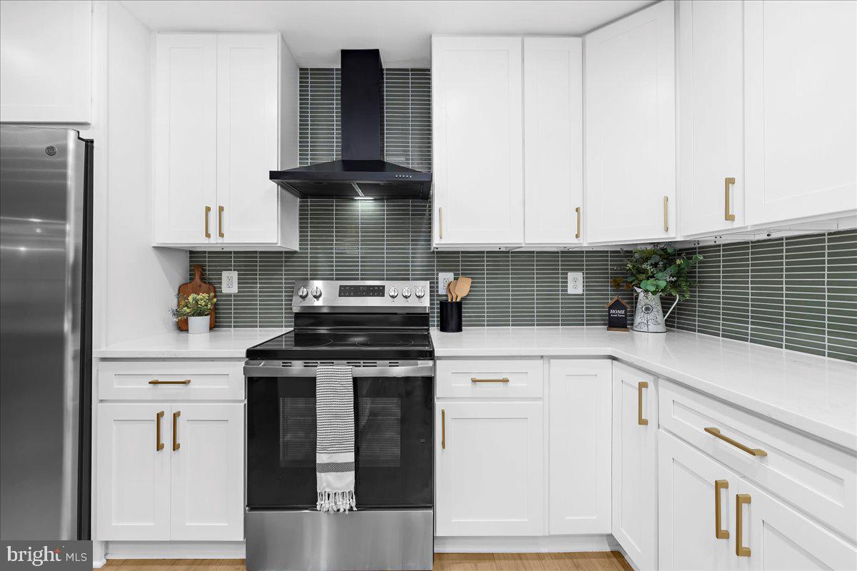 624 Sutton Drive Pasadena, MD 21122 - Photo 6 of 64 a kitchen with cabinets appliances and a window