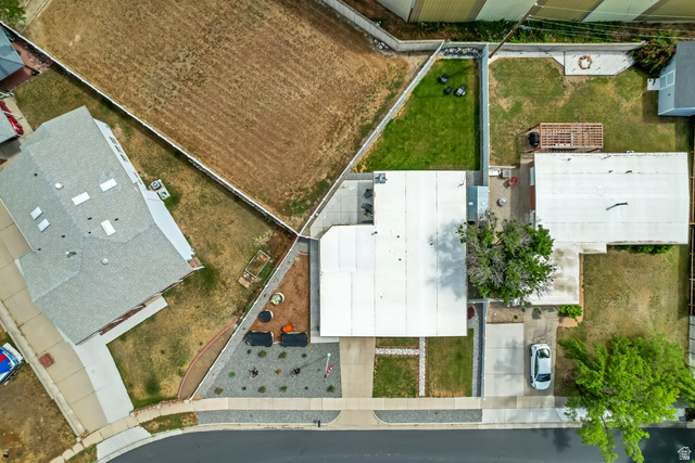 48 Moon Ridge Drive Murray, UT 84107 - Photo 27 of 30 Aerial view showcasing a property with a front yard, a paved driveway, and a partially landscaped backyard