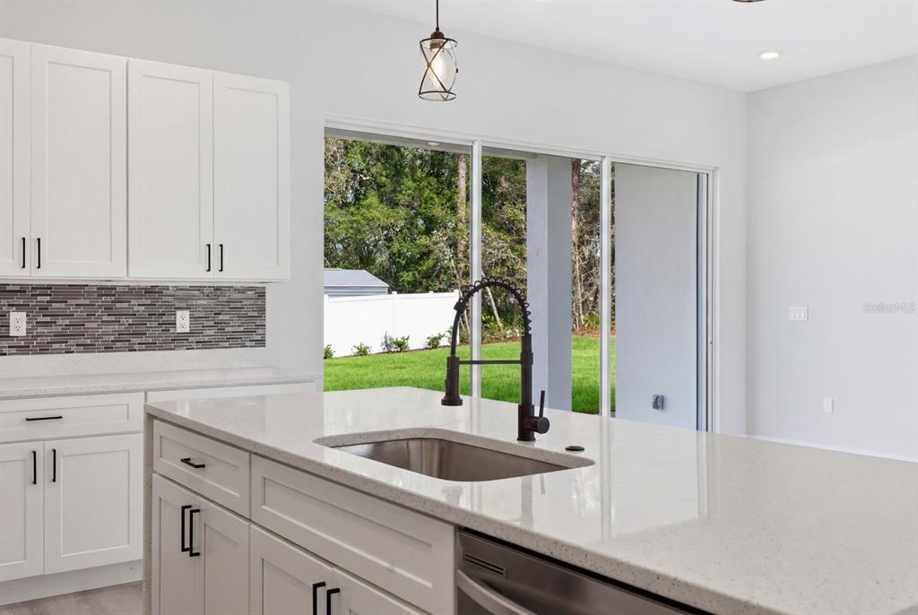 4487 Southwest 152nd Street Ocala, FL 34473 - Photo 15 of 41 a kitchen with a sink and large window