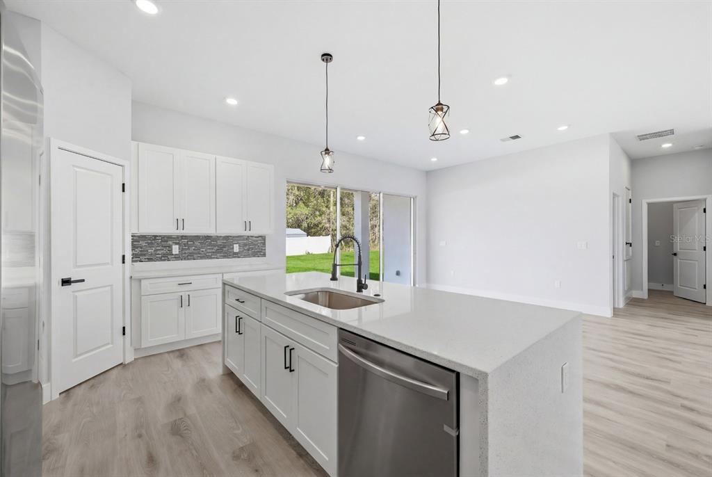 4487 Southwest 152nd Street Ocala, FL 34473 - Photo 16 of 41 a kitchen with a sink window and cabinets