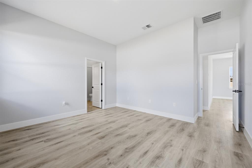 4487 Southwest 152nd Street Ocala, FL 34473 - Photo 19 of 41 a view of an empty room with wooden floor