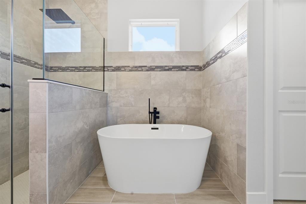 4487 Southwest 152nd Street Ocala, FL 34473 - Photo 20 of 41 a white bath tub sitting in a bathroom
