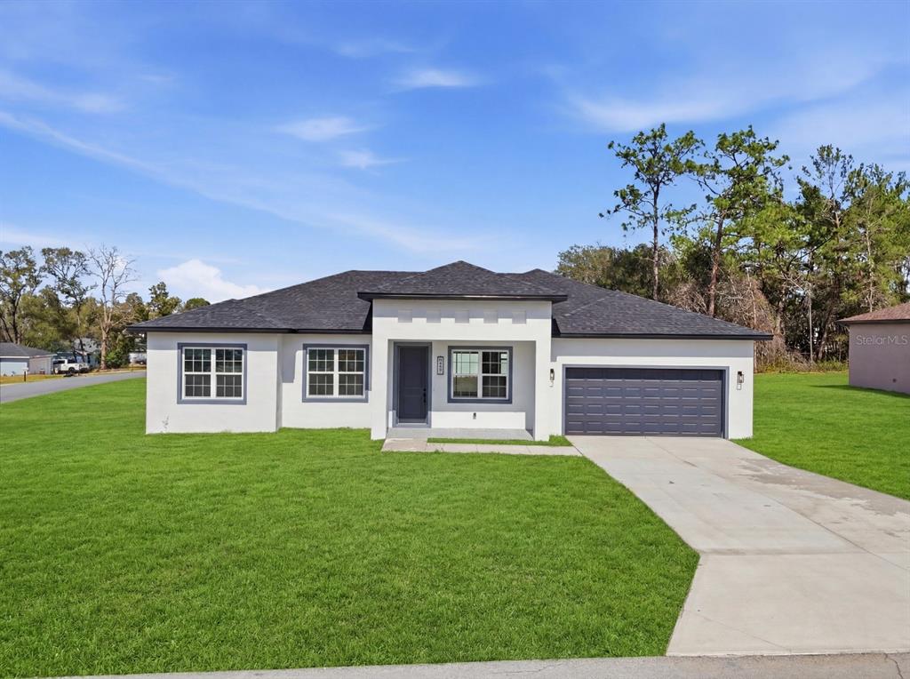 4487 Southwest 152nd Street Ocala, FL 34473 - Photo 2 of 41 a front view of house with yard and green space