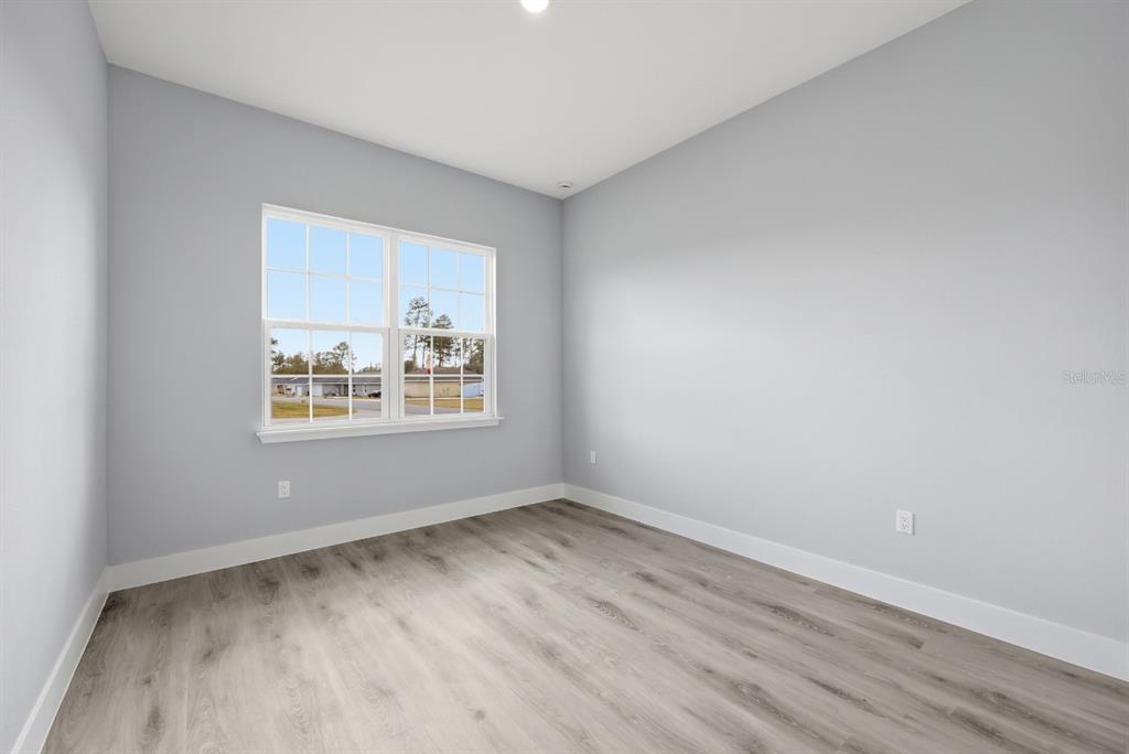 4487 Southwest 152nd Street Ocala, FL 34473 - Photo 26 of 41 wooden floor in an empty room with a window
