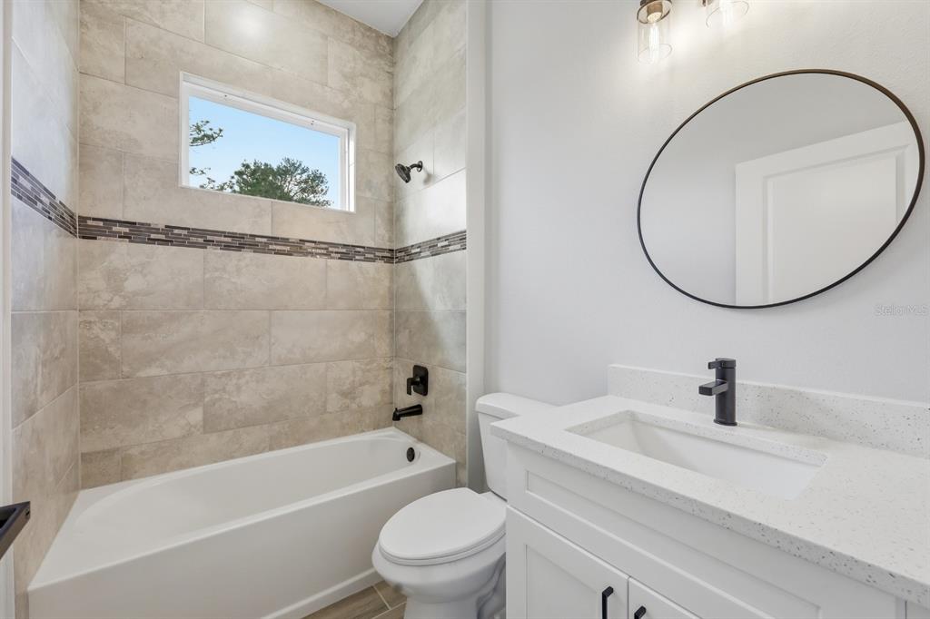 4487 Southwest 152nd Street Ocala, FL 34473 - Photo 28 of 41 a bathroom with a toilet a sink and a bathtub