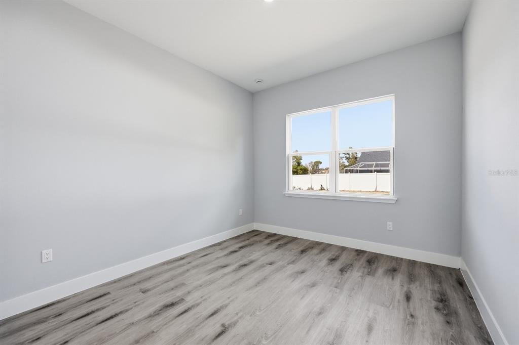 4487 Southwest 152nd Street Ocala, FL 34473 - Photo 32 of 41 wooden floor in an empty room with a window