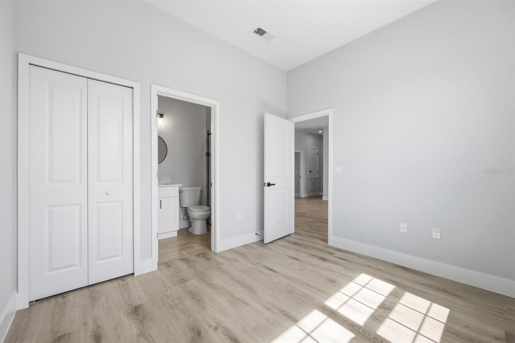 4487 Southwest 152nd Street Ocala, FL 34473 - Photo 33 of 41 a view of an empty room with wooden floor and a bathroom