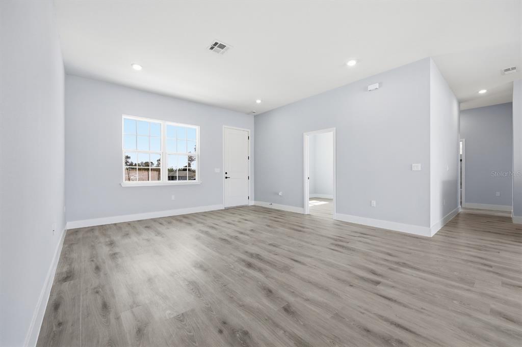 4487 Southwest 152nd Street Ocala, FL 34473 - Photo 34 of 41 an empty room with wooden floor and windows