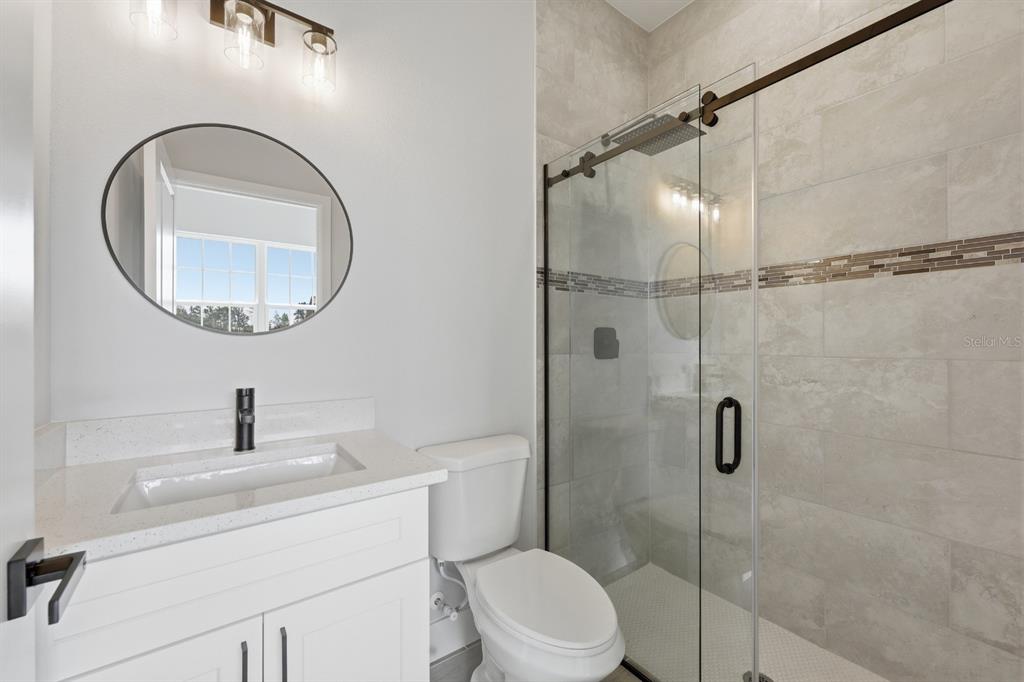 4487 Southwest 152nd Street Ocala, FL 34473 - Photo 35 of 41 a bathroom with a sink a toilet and a mirror