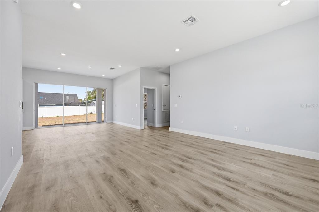 4487 Southwest 152nd Street Ocala, FL 34473 - Photo 36 of 41 an empty room with wooden floor and windows