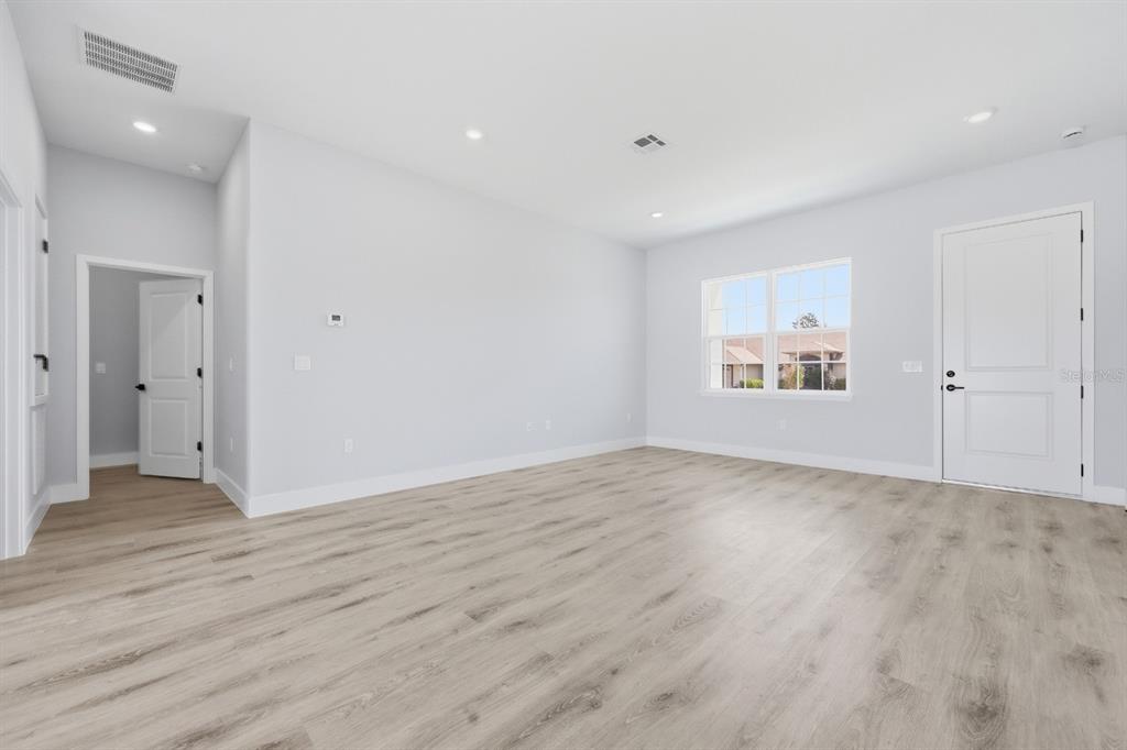 4487 Southwest 152nd Street Ocala, FL 34473 - Photo 37 of 41 an empty room with wooden floor and windows