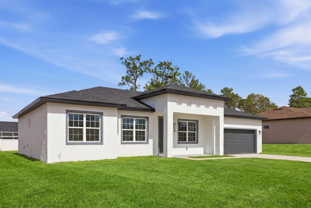 4487 Southwest 152nd Street Ocala, FL 34473 - Photo 4 of 41 a front view of a house with a garden