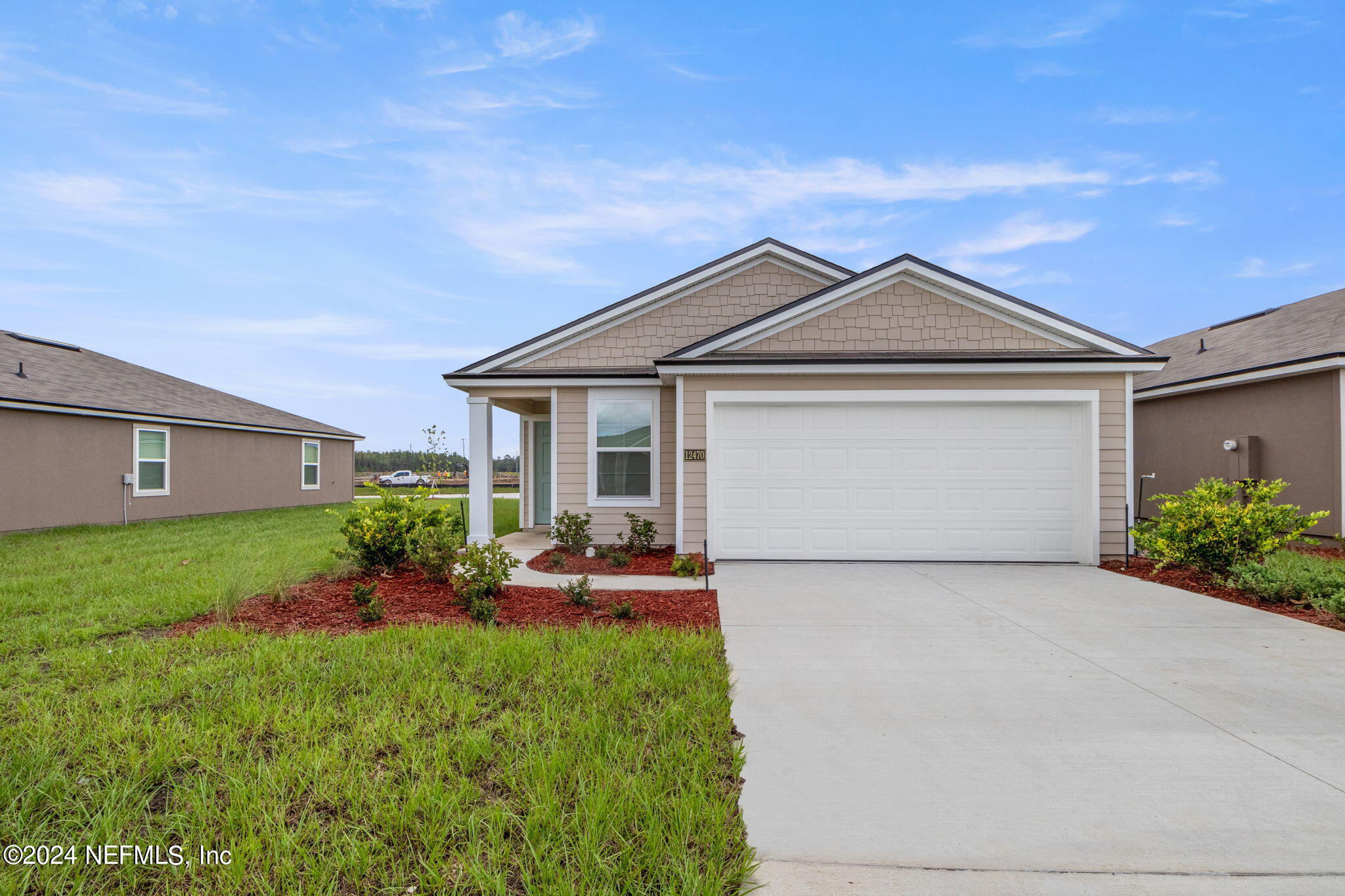 12470 Rubber Fig Terrace Jacksonville, FL 32218 - Photo 1 of 20 a front view of a house with garden