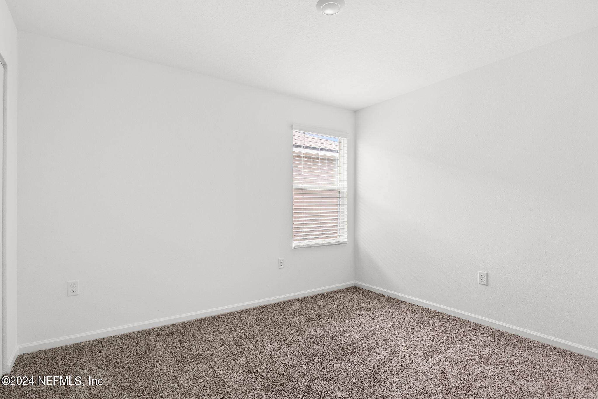 12470 Rubber Fig Terrace Jacksonville, FL 32218 - Photo 12 of 20 an empty room with a window