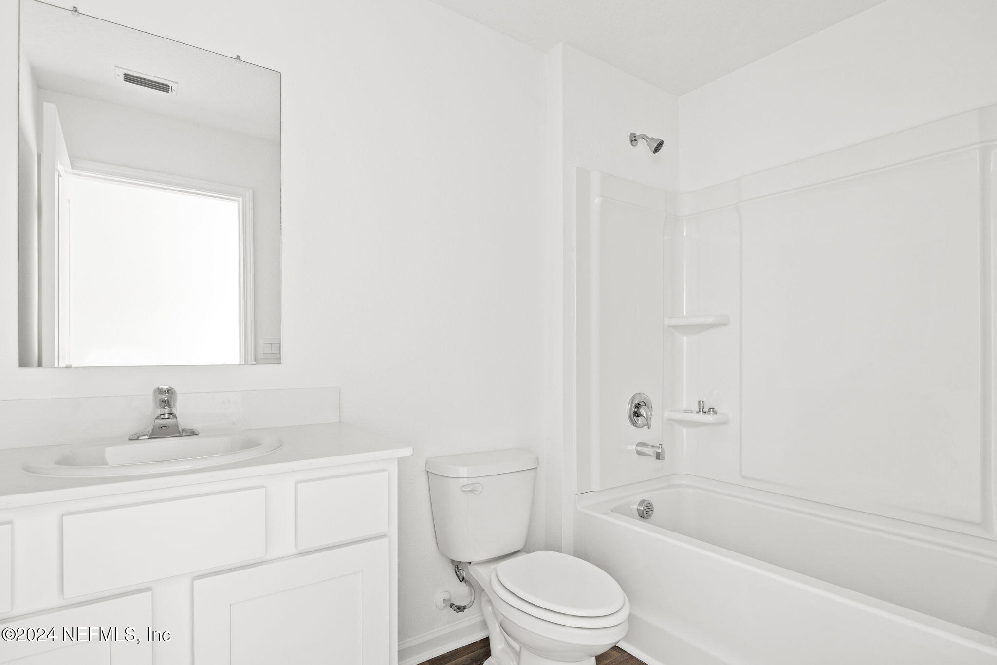 12470 Rubber Fig Terrace Jacksonville, FL 32218 - Photo 14 of 20 a bathroom with a bathtub shower sink vanity mirror and toilet