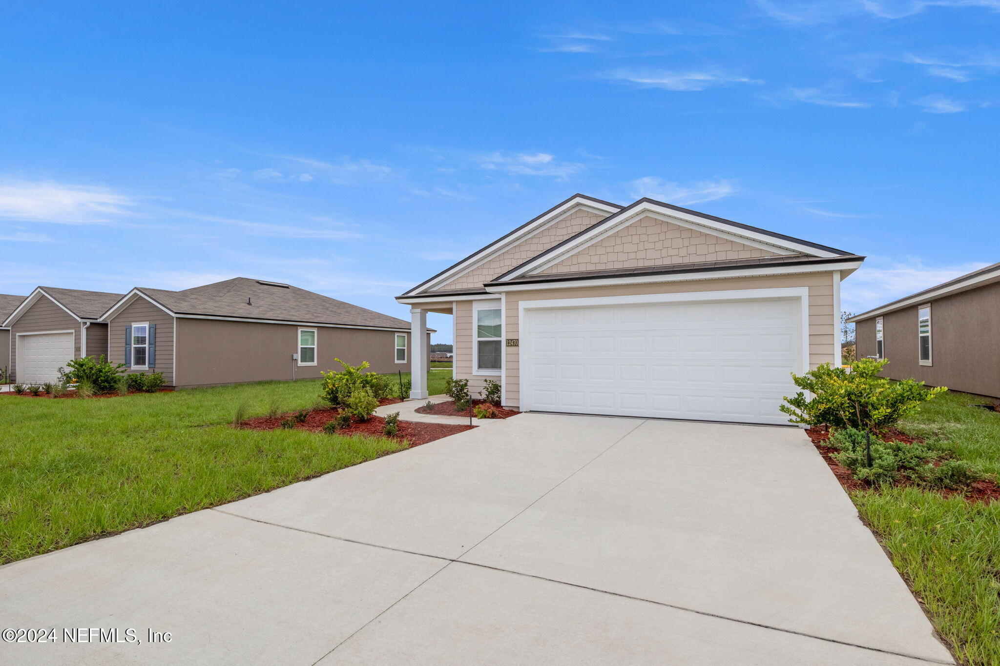 12470 Rubber Fig Terrace Jacksonville, FL 32218 - Photo 2 of 20 a front view of a house with a yard and garage