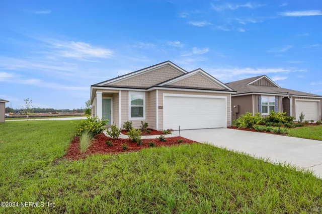 a backyard of a house with table and chairs