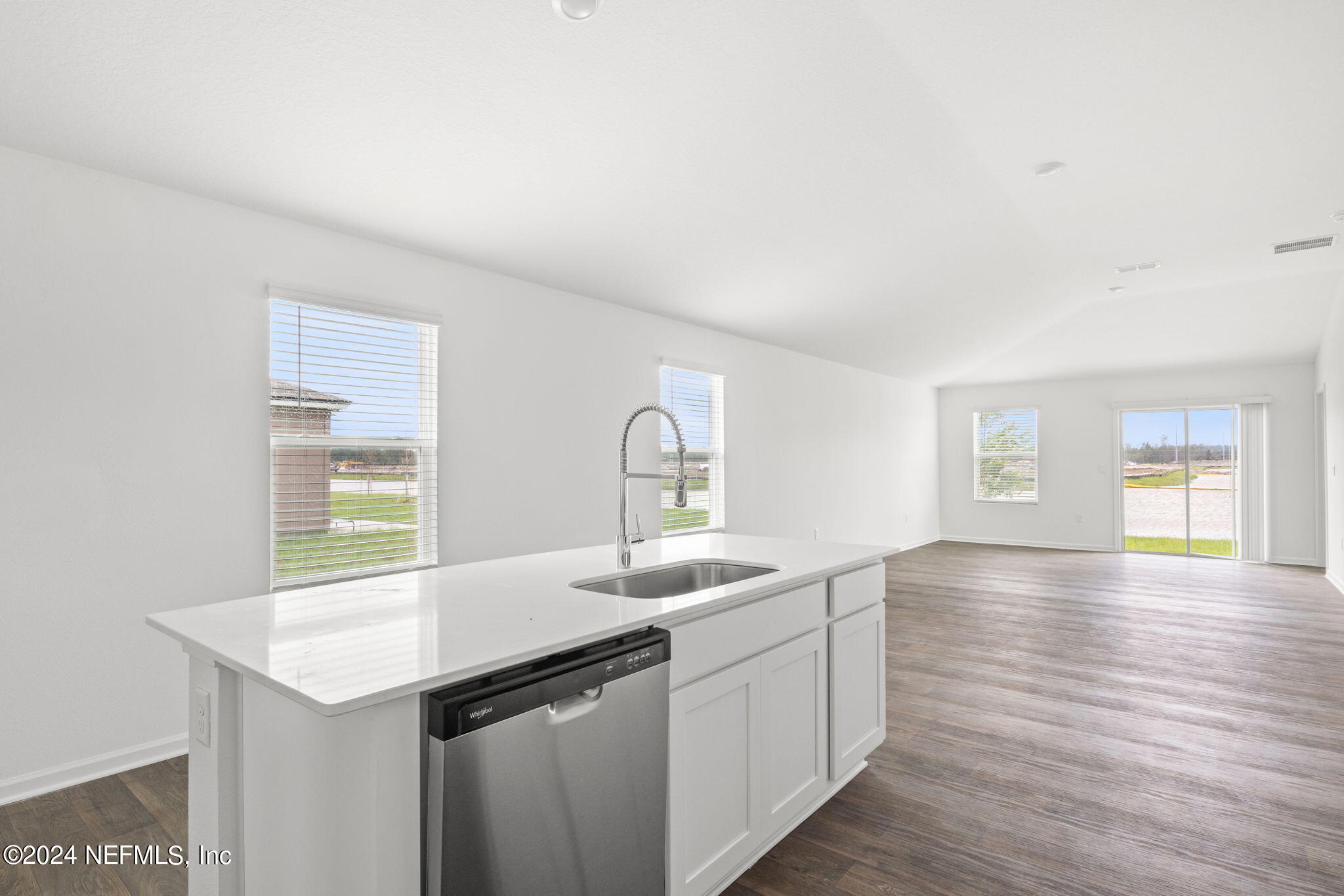 12470 Rubber Fig Terrace Jacksonville, FL 32218 - Photo 4 of 20 a kitchen with a sink cabinets and wooden floor