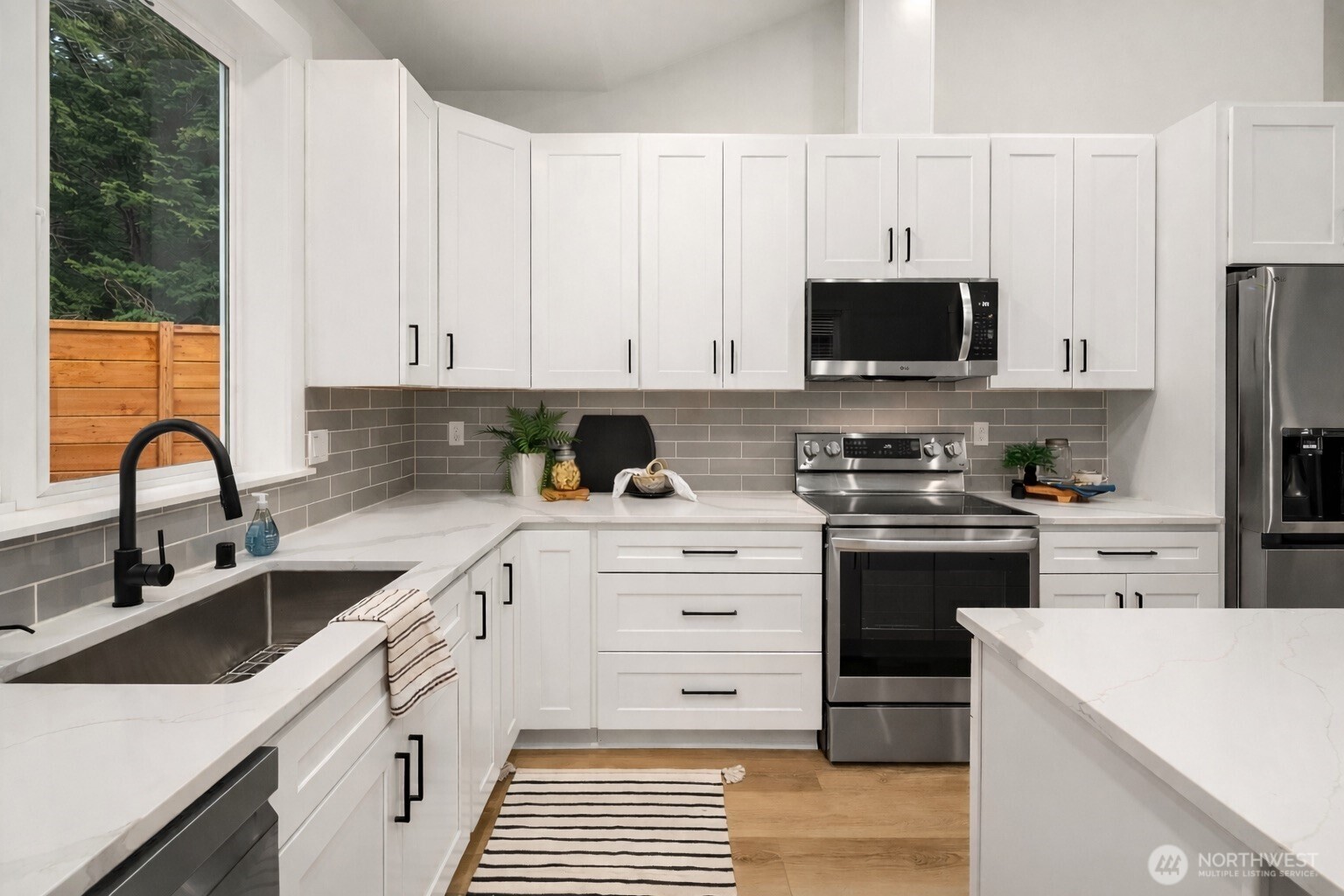 4 Twin Flower Circle Bellingham, WA 98229 - Photo 13 of 31 a kitchen with granite countertop white cabinets and stainless steel appliances