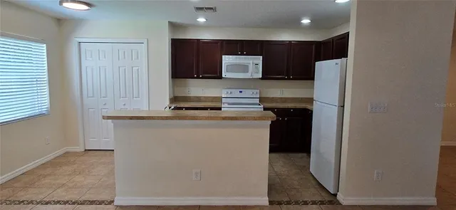 a kitchen with a refrigerator and a stove