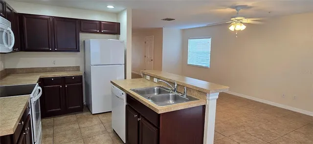 a kitchen with a sink appliances and cabinets