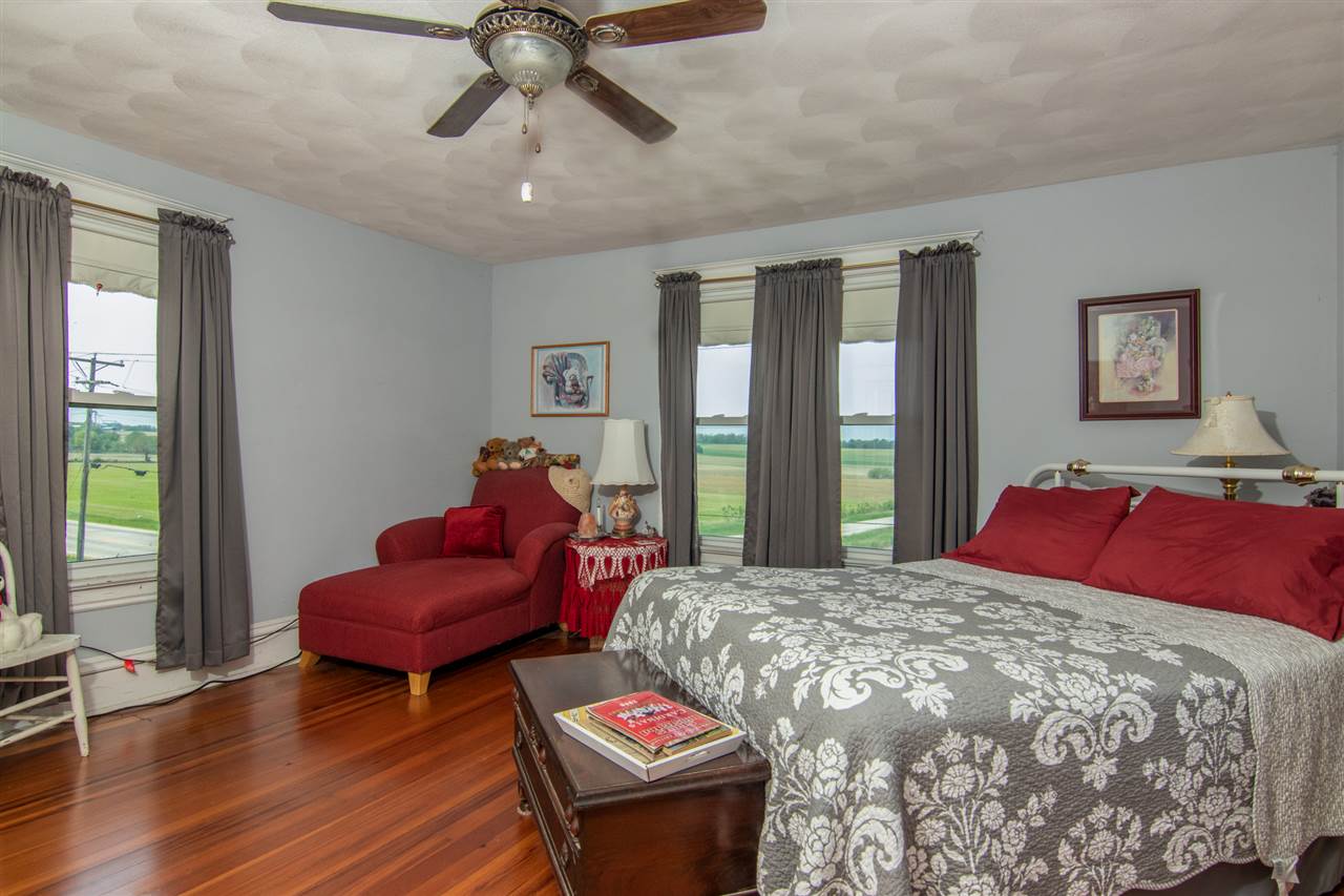 10494 Freeport Road Durand, IL 61024 - Photo 13 of 40 a bedroom with a bed and wooden floor