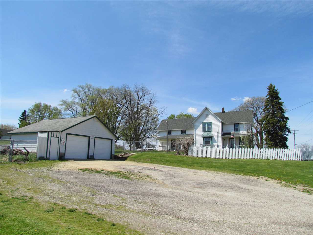 10494 Freeport Road Durand, IL 61024 - Photo 21 of 40 a front view of a house with a garden and yard