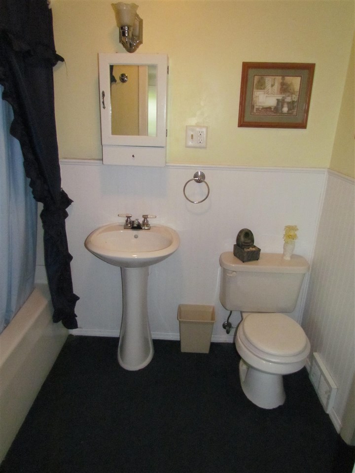 10494 Freeport Road Durand, IL 61024 - Photo 38 of 40 a bathroom with a toilet sink and mirror