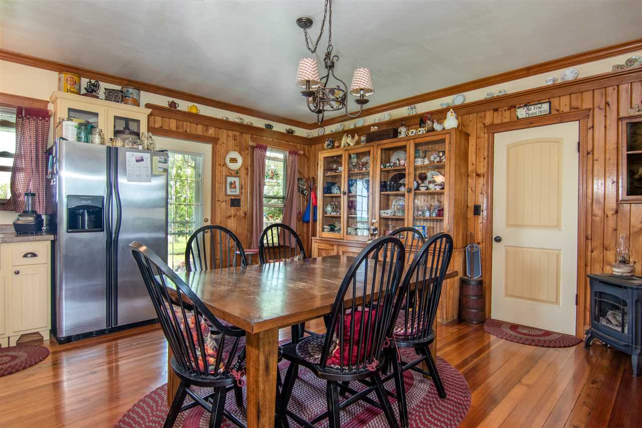 10494 Freeport Road Durand, IL 61024 - Photo 5 of 40 a dining room with furniture a chandelier and wooden floor