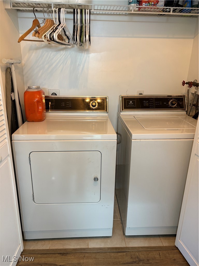 935 Canyon View Road, Unit 104 Northfield, OH 44067 - Photo 17 of 46 Laundry room featuring independent washer and dryer, light wood finished floors, and laundry area
