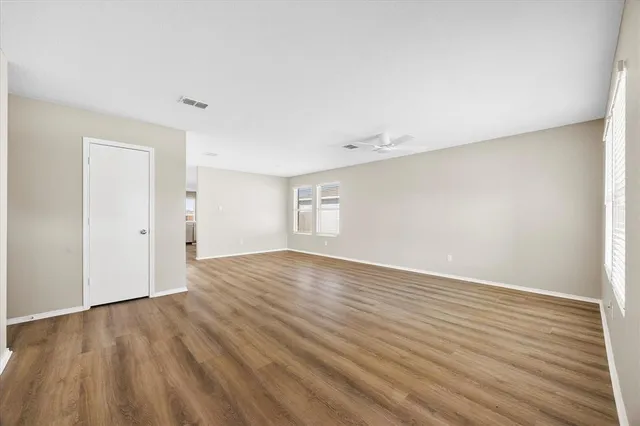 a view of an empty room and wooden floor