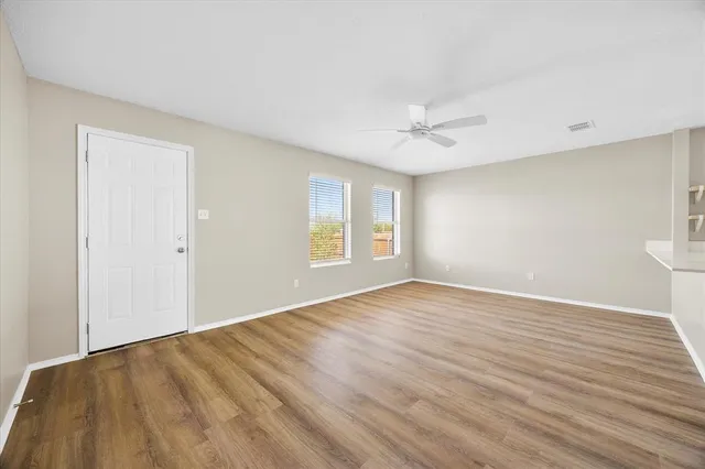 wooden floor in an empty room with a window