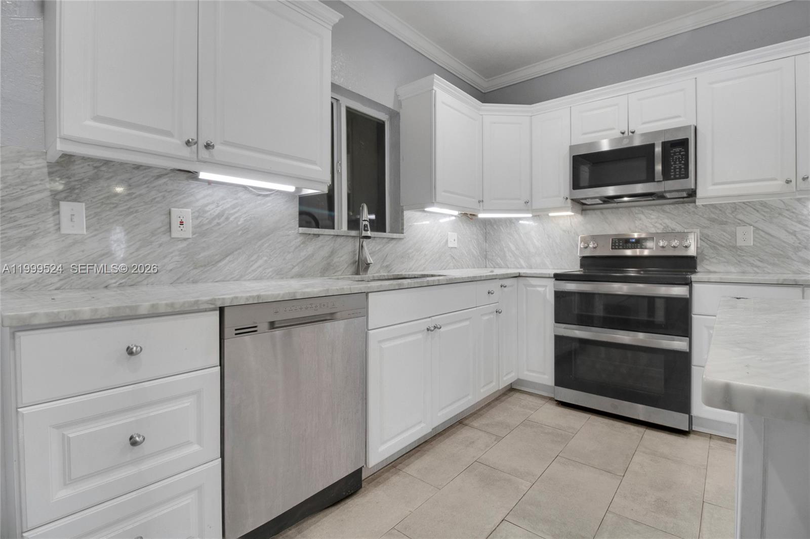 1925 Northwest 49th Street Miami, FL 33142 - Photo 12 of 30 a kitchen with stainless steel appliances granite countertop a sink and a stove
