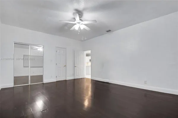 a view of wooden floor and windows in a room