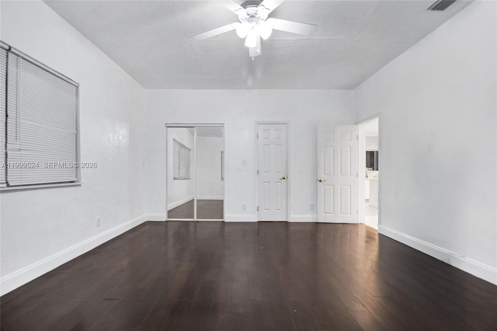 1925 Northwest 49th Street Miami, FL 33142 - Photo 15 of 30 a view of wooden floor and windows in a room