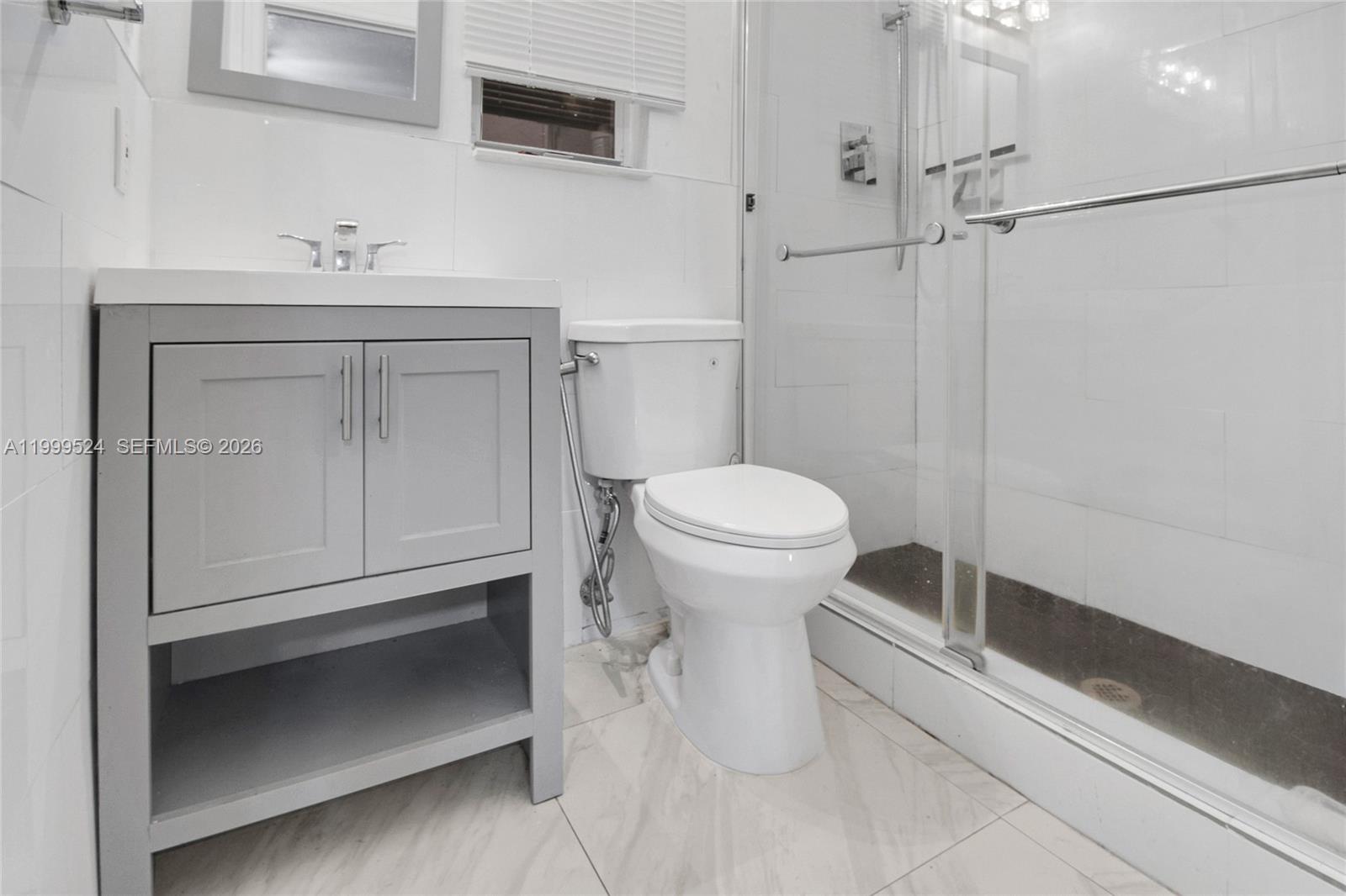 1925 Northwest 49th Street Miami, FL 33142 - Photo 19 of 30 a bathroom with a sink toilet and vanity