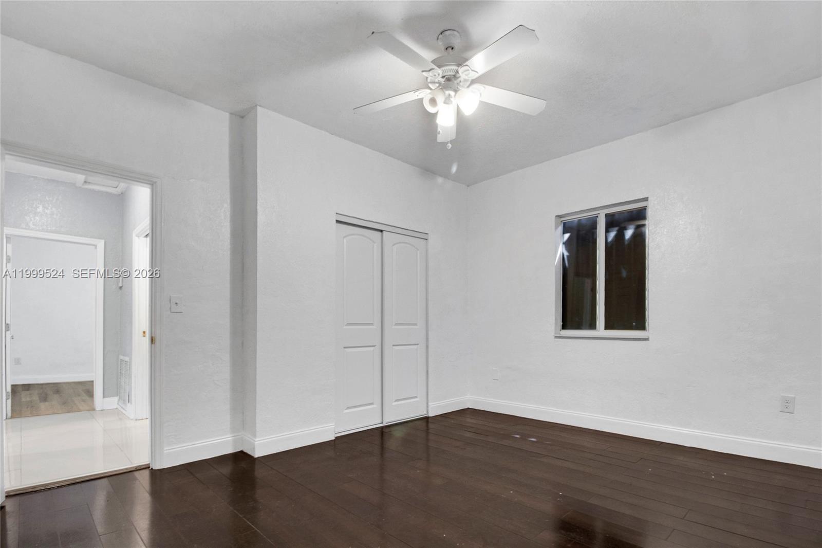 1925 Northwest 49th Street Miami, FL 33142 - Photo 20 of 30 an empty room with wooden floor and windows