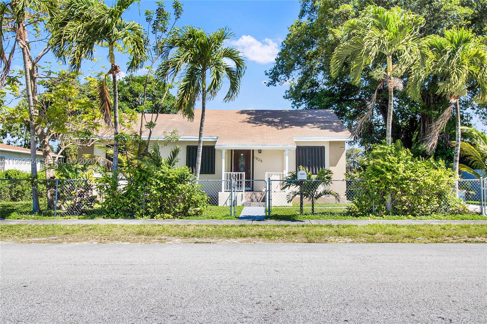 1925 Northwest 49th Street Miami, FL 33142 - Photo 2 of 30 a front view of a house with a yard