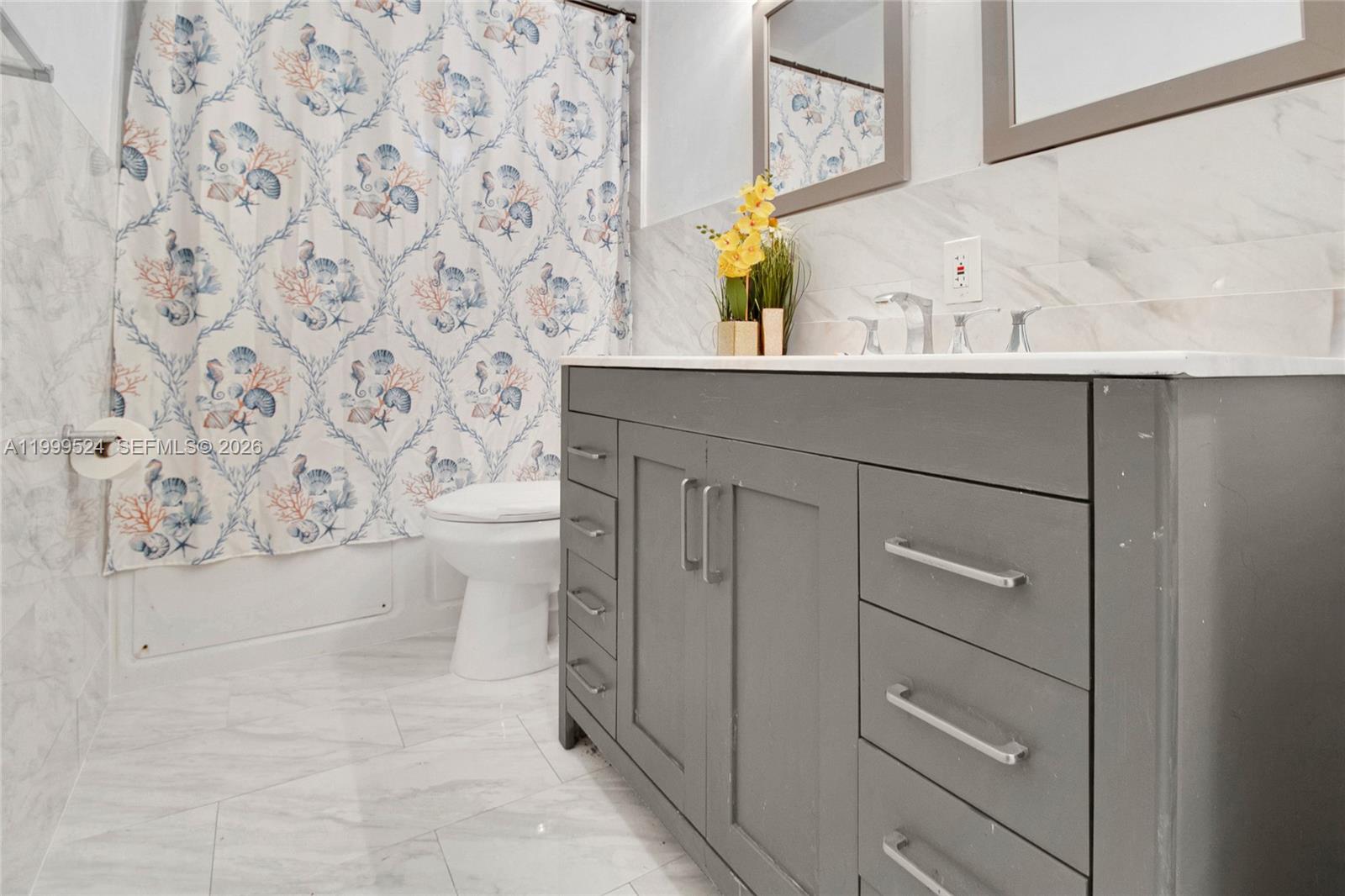 1925 Northwest 49th Street Miami, FL 33142 - Photo 23 of 30 a bathroom with a sink toilet and mirror